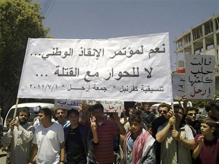 In this citizen journalism image made on a mobile phone and provided by Shaam News Network, Anti-Syrian President Bashar Assad protesters, hold up banners during a demonstration against the Syrian regime, in Kfar Nebel village near the the province of Edlib, northwest Syria, on Friday July 1, 2011. Human rights activists say three people have been killed as tens of thousands of Syrians shouting for President Bashar Assad to leave office take to the streets across the country. The two Arabic banners read: \"Yes to national salvation conference, no to dialogue with the killers, left, and Aleppo said its word, Leave, right\". (AP Photo/Shaam News Network) EDITORIAL USE ONLY, NO SALES, THE ASSOCIATED PRESS IS UNABLE TO INDEPENDENTLY VERIFY THE AUTHENTICITY, CONTENT, LOCATION OR DATE OF THIS HANDOUT PHOTO